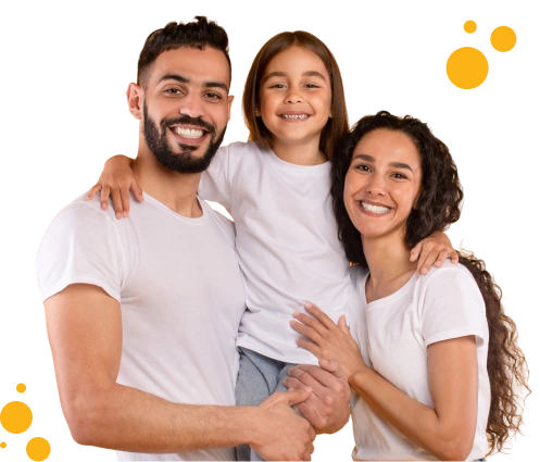 Happy family of three smiling at the camera, with the child in the center being held by both parents, all wearing white shirts against a dark background with cheerful orange bubble graphics