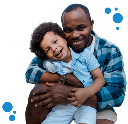 Smiling father and son hugging joyfully, both wearing blue plaid and light-colored clothing, surrounded by playful blue bubble graphics