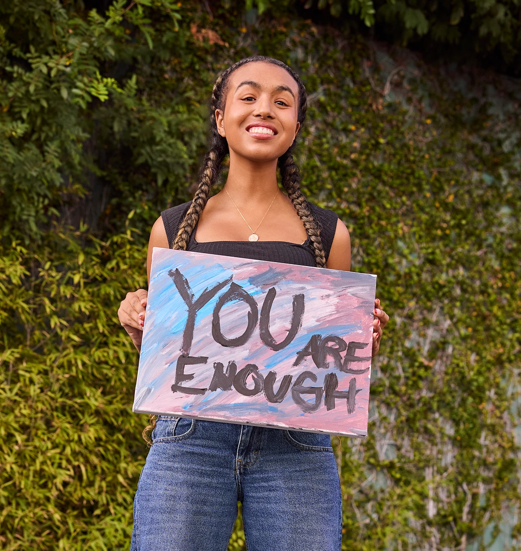 You are enough text in a paper holding by a women